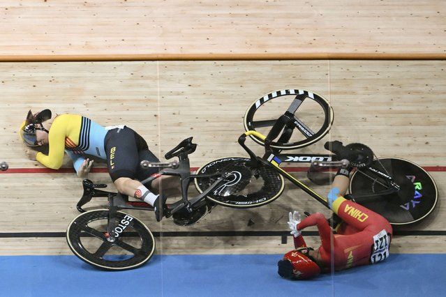 Belgium's Nicky Degrendele (L) and China's Yuan Liying (R) suffer a crash during the women's track cycling keirin quarter-final of the Paris 2024 Olympic Games at the Saint-Quentin-en-Yvelines National Velodrome in Montigny-le-Bretonneux, south-west of Paris, on August 8, 2024. (Photo by Sebastien Bozon/AFP Photo)