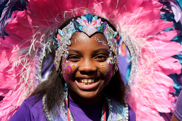 A child poses for a photo, during Notting Hill Carnival, in London, Britain on August 26, 2024. (Photo by Hollie Adams/Reuters)