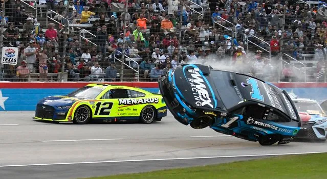 Ryan Blaney (12) passes by Ross Chastain (1) lifting off the track after making contact with Kyle Busch, right, during the NASCAR All-Star auto race at Texas Motor Speedway in Fort Worth, Texas, Sunday, May 22, 2022. (Photo by Randy Holt/AP Photo)