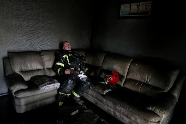 A firefighter takes a break during a fire at a house following a military strike, amid Russia's attack on Ukraine, at a residential area in Kharkiv, Ukraine on June 7, 2022. (Photo by Ivan Alvarado/Reuters)