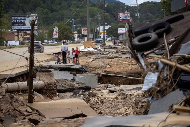 Swannanoa residents walk through devastating flood damage after Hurricane Helene caused widespread flooding, downed trees, and power outages in western North Carolina, September 29, 2024.  (Photo by Travis Long/The News & Observer)