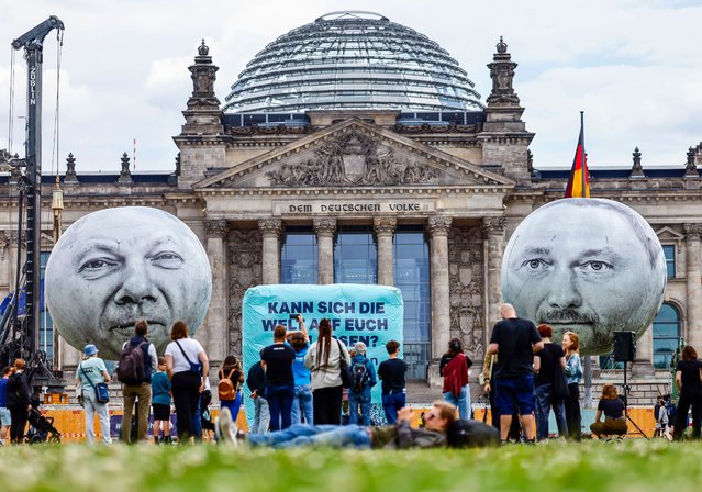 Large balloons with the faces of the German Chancellor Olaf Scholz (L) and the Finance Minister Christian Lindner float in front of the Reichstag building in Berlin, Germany, 03 July 2023. Activists of ONE, a global campaign and advocacy organisation committed to ending extreme poverty, protest against planned German budget cuts for development aid. (Photo by Hannibal Hanschke/EPA/EFE/Rex Features/Shutterstock)