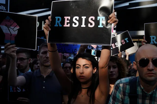 People protest U.S. President Donald Trump's announcement that he plans to reinstate a ban on transgender individuals from serving in any capacity in the U.S. military, in Times Square, in New York City, New York, U.S., July 26, 2017. (Photo by Carlo Allegri/Reuters)