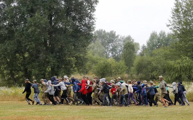 In this photo taken on Friday, July 14, 2017, students at a paramilitary camp for children take part in orientation exercises outside Kiev, Ukraine. (Photo by Efrem Lukatsky/AP Photo)