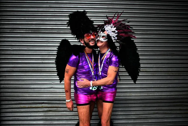 A gay couple embrace as they watch the Belfast Gay Pride march taking place on August 5, 2017 in Belfast, Northern Ireland. The province is the only part of the United Kingdom which does not recognise same s*x marriage. The Irish Republic's first gay prime minister Taoiseach Leo Varadkar today predicted it is only a matter of time before same s*x marriage is legalised in the north. Mr Varadkar was speaking at a Pride breakfast event. (Photo by Charles McQuillan/Getty Images)