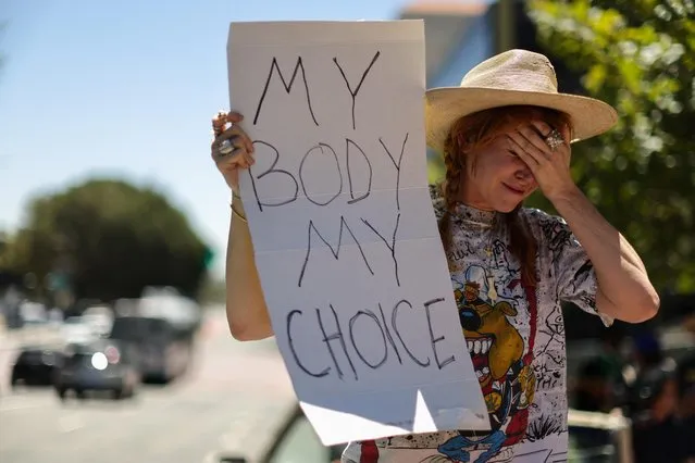Eleanor Wells, 34 holds a sign, as abortion rights protesters demonstrate after the U.S. Supreme Court ruled in the Dobbs v Women’s Health Organization abortion case, overturning the landmark Roe v Wade abortion decision in Los Angeles, California, U.S., June 24, 2022. (Photo by Lucy Nicholson/Reuters)