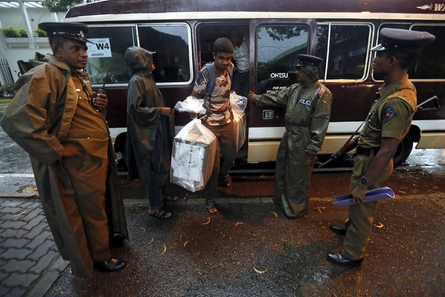 Police officers escort a polling officer carrying a sealed ballot box to a counting centre in Colombo, August 17, 2015. Sri Lanka held a parliamentary election on Monday in which ex-president Mahinda Rajapaksa was trying to stage a political comeback, as the leader who toppled him in January manoeuvred to block his path back to power. (Photo by Dinuka Liyanawatte/Reuters)
