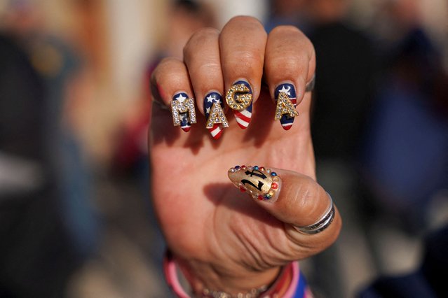 A supporter of Republican presidential nominee former President Donald Trump shows her "Make America Great Again" (MAGA) themed decorated nails outside the venue on the day of a campaign rally in Pittsburgh, Pennsylvania on November 4, 2024. (Photo by Seth Herald/Reuters)