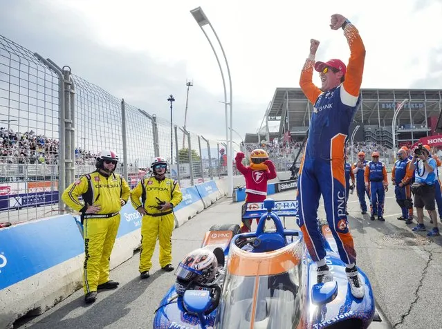 Scott Dixon, of New Zealand, celebrates on his car after winning an IndyCar auto race in Toronto, Sunday, July 17, 2022. (Photo by Mark Blinch/The Canadian Press via AP Photo)
