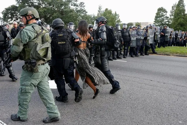 Protestor Ieshia Evans is detained by law enforcement near the headquarters of the Baton Rouge Police Department in Baton Rouge, Louisiana, U.S. July 9, 2016. (Photo by Jonathan Bachman/Reuters)