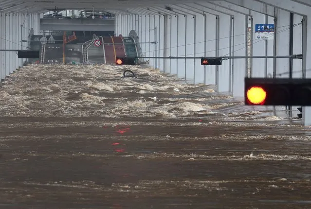 A bridge is submerged by torrential rain of the previous day at Han river in Seoul, South Korea on August 9, 2022. At least eight people were killed and six people missing after one of the heaviest rain storms in 80 years hit Seoul, flooding streets and subway stations and causing blackouts. (Photo by Yonhap via Reuters)