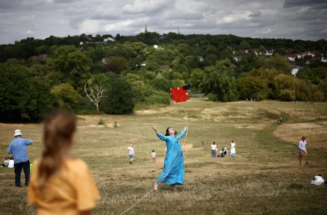 A person flies a kite on Parliament Hill during “Fly With Me”, a kite festival celebrating Afghan culture, held in solidarity with the people of Afghanistan during the one year anniversary of the country falling into Taliban rule, in London, Britain on August 20, 2022. (Photo by Henry Nicholls/Reuters)