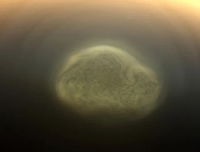 A true color image of Titan's colorful south polar vortex captured by NASA's Cassini spacecraft before a distant flyby of Saturn's moon Titan on June 27, 2012, shows a south polar vortex, or a mass of swirling gas, around the pole in the atmosphere of the moon. The south pole of Titan which is 3,200 miles (5,150 km) across is near the center of the view. The formation of the vortex at Titan's south pole may be related to the coming southern winter and the start of what will be a south polar hood. These new, more detailed images are only possible because of Cassini's newly inclined orbits, which are the next phase of Cassini Solstice Mission. (Photo by Reuters/NASA/JPL-Caltech/Space Science Institute/Handout)