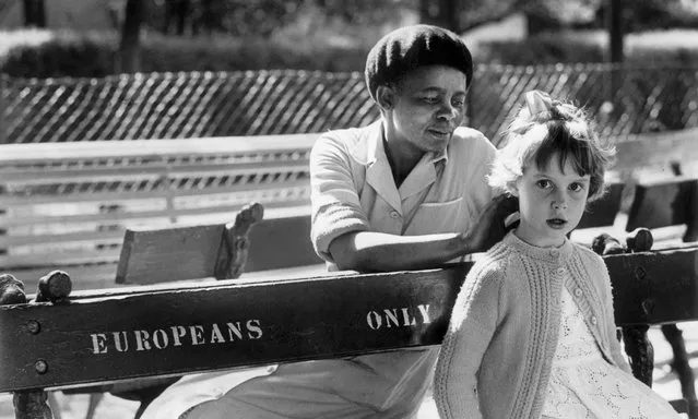A girl and her maid on a “Europeans only” bench in Johannesburg, 1956. Working as a black photographer in apartheid South Africa was not easy. You had to always know where you were and who was around you. If the police were there, you couldn’t take photos – and the police were always there. If it was difficult for me to get a shot openly, I’d have to improvise: hide my camera in a loaf of bread, a half-pint of milk, even a Bible. When I got back to the office, I had to have a picture with me no matter what. My editors at the Rand Daily Mail would not take any nonsense”. (Photo by Peter Magubane)