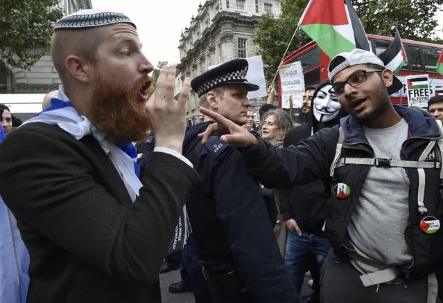 Demonstrators argue during a protest outside Downing Street in London, Britain September 9, 2015. Pro-Israel and pro-Palestine demonstrators waved banners and scuffled during a protest ahead of a two-day visit to London by Israeli Prime Minster Benjamin Netanyahu. (Photo by Toby Melville/Reuters)
