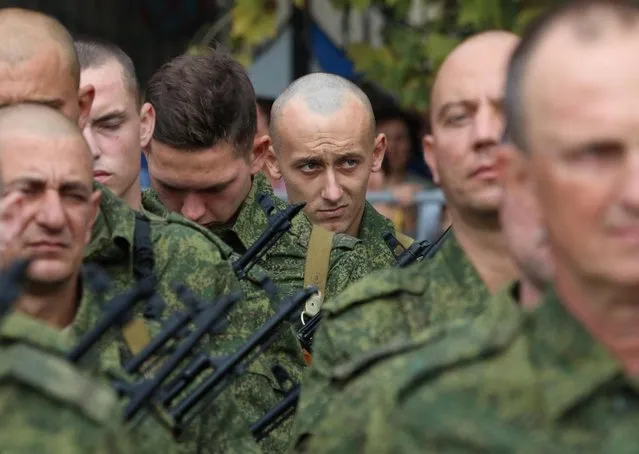 Reservists drafted during the partial mobilisation attend a ceremony before departure for military bases, in Sevastopol, Crimea on September 27, 2022. (Photo by Alexey Pavlishak/Reuters)