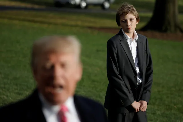 President Trump talks with the reporters as his son Barron waits for him while departing the White House for Palm Beach on November 21, 2017. (Photo by Carlos Barria/Reuters)