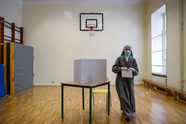 A nun wears a protective face mask as she casts her ballot during Poland's Presidential elections on June 28, 2020 in Krakow, Poland.The latest polling suggests current President Andrzej Duda may not claim enough votes to win in the first round and could face a run-off election against Warsaw mayor and presidential candidate of the center-right main opposition party, Civic Platform (PO), Rafal Trzaskowski. Todays election was originally scheduled for May but was postponed due to the coronavirus pandemic. (Photo by Omar Marques/Getty Images)