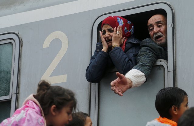 Migrants react after boarding a train at the station in Tovarnik, Croatia, September 20, 2015. (Photo by Antonio Bronic/Reuters)