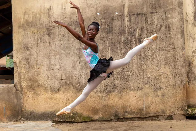 A student of the Leap of Dance Academy, Olamide Olawale, performs a dance routine in Okelola street in Ajangbadi, Lagos, on July 3, 2020. The Leap of Dance Academy is a ballet school in a poor district of sprawling megacity of Lagos that aims to bring classical dance to underprivileged children in Africa's most populous nation. (Photo by Benson Ibeabuchi/AFP Photo)
