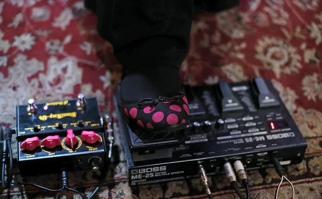 Gisele Marie, a Muslim woman and professional heavy metal musician, checks her guitar wah pedal before a concert in Sao Paulo December 16, 2014. (Photo by Nacho Doce/Reuters)