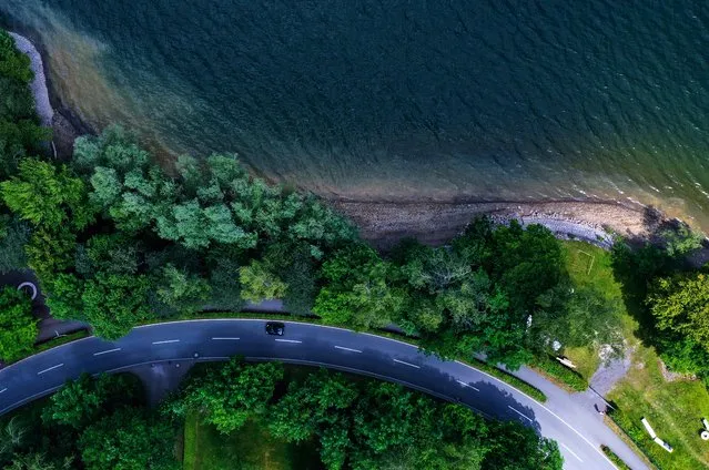 An aerial view taken on June 12, 2020 shows a car driving on a street leading along the banks of the Moehnesee lake in Moehnesee, western Germany. (Photo by Ina Fassbender/AFP Photo)