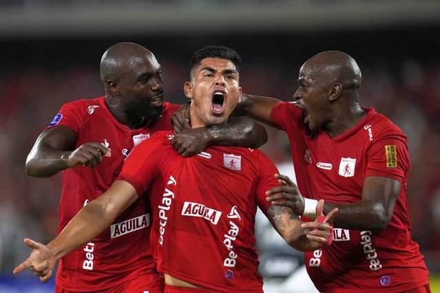 Luis Ramos of Colombia's America, center, celebrates with teammates after scoring his side's opening goal against Brazil's Corinthians during a Copa Sudamericana Group C soccer match at Pascual Guerrero stadium in Cali, Colombia, Tuesday, April 8, 2025. (Photo by Fernando Vergara/AP Photo)