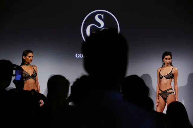 Attendees watch as a model presents creations from God Save Queens Spring/Summer 2017 collection during New York Fashion Week in the Manhattan borough of New York, U.S., September 7, 2016. (Photo by Lucas Jackson/Reuters)