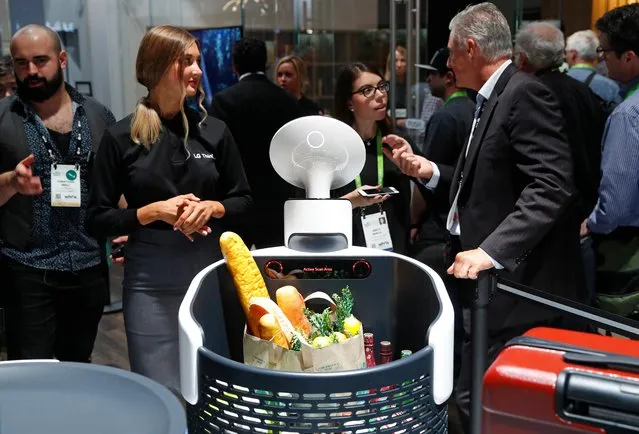 The Cloi shopping cart robot, center, appears on display at the LG booth during CES International, Tuesday, January 9, 2018, in Las Vegas. (Photo by John Locher/AP Photo)