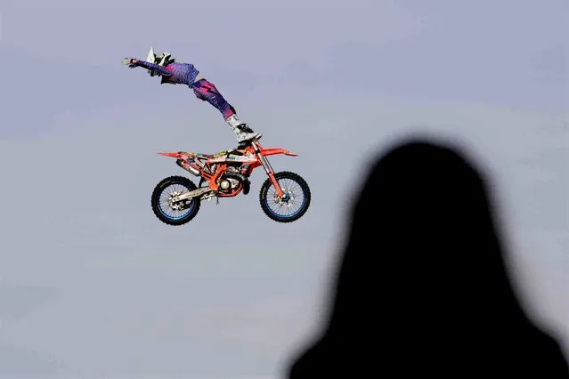 A rider performs during a motocross freestyle contest during the EICMA exhibition motorcycle fair in Milan, Italy, Friday, November 11, 2022. (Photo by Luca Bruno/AP Photo)