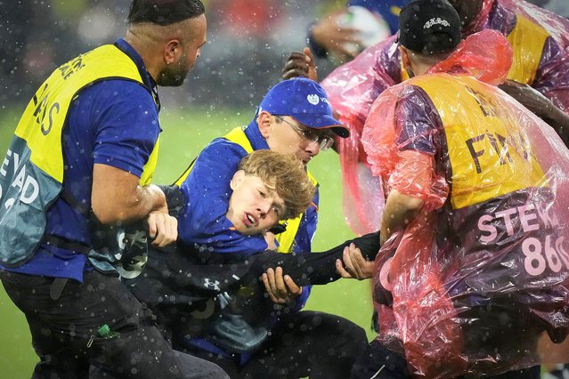 Stewards restrain a young man who entered the pitch attempting to get a selfie with Portugal's Cristiano Ronaldo before the Nations League semifinal soccer match between Portugal and Germany at the Munich Football Arena, in Munich, Germany, Wednesday, June 4, 2025. (Photo by Matthias Schrader/AP Photo)