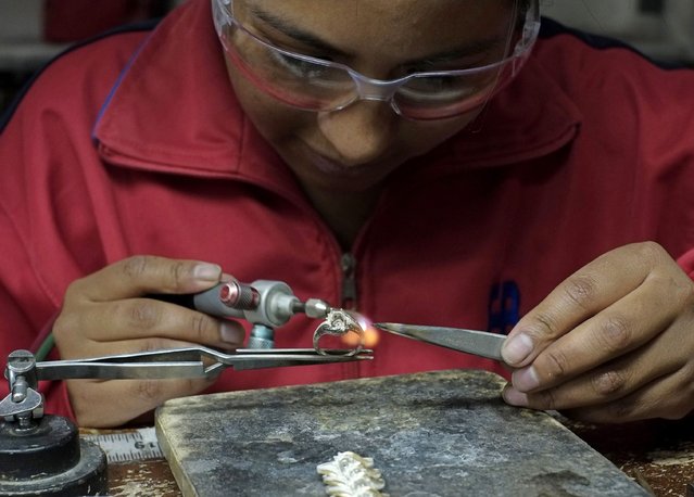 An employee of the jewelry manufacturer Exportaciones Bolivianas works on a ring in La Paz, November 14, 2014. (Photo by David Mercado/Reuters)