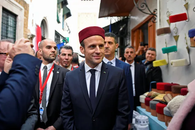 French President Emmanuel Macron wears a fez during his tour of the Medina (old town) of the Tunisian capital Tunis, Tunisia, February 1, 2018. (Photo by Eric Feferberg/Reuters)