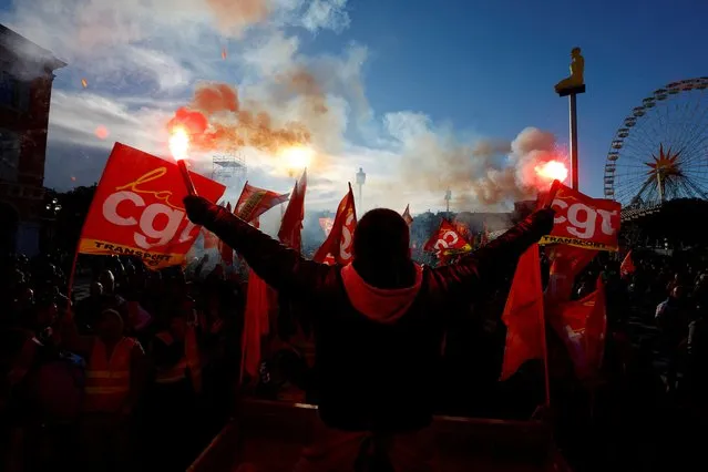 Protesters hold CGT labour union flags and flares during a demonstration against the French government's pension reform plan in Nice as part of a day of national strike and protests in France on January 19, 2023. (Photo by Eric Gaillard/Reuters)