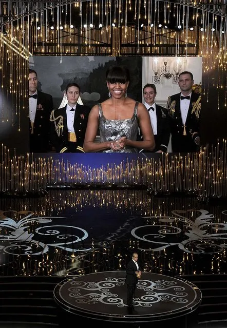 First lady Michelle Obama, appearing on screen, and actor Jack Nicholson present the award for best picture. (Photo by Chris Pizzello/Invision)