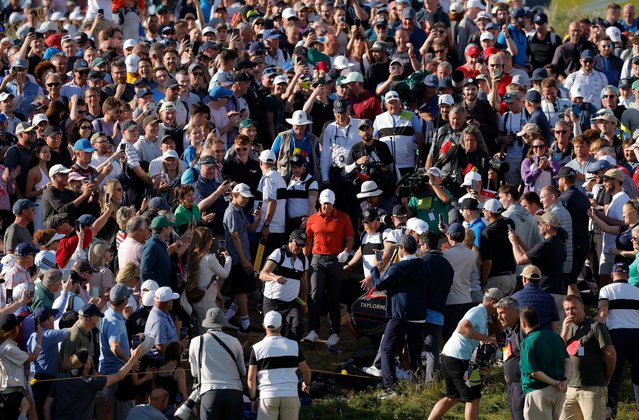Rory McIlroy is escorted through a mass of his supporters after he played his 2nd shot to the 17th green from rough to the right of the fairway during day three of the 153rd Open Golf Championship at the Royal Portrush golf club in Northern Ireland on Saturday, July 19, 2025. (Photo by Tom Jenkins/The Guardian)