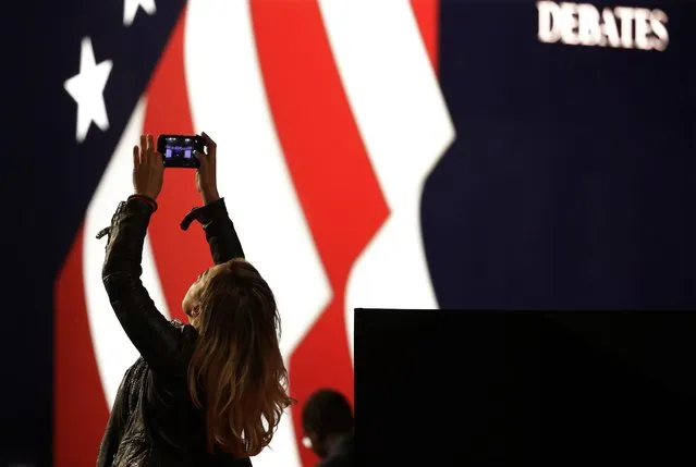 Lena Gjokaj takes a cellphone photo of the stage for the presidential debate between Democratic presidential candidate Hillary Clinton and Republican presidential candidate Donald Trump, at Hofstra University in Hempstead, N.Y., Monday, September 26, 2016. The presidential debates are expected to set records when it comes to television audiences. From streaming on Twitter to Instagram, there are a few ways to stream at least parts of the debate, and get behind-the-scenes content and commentary. (Photo by Julio Cortez/AP Photo)