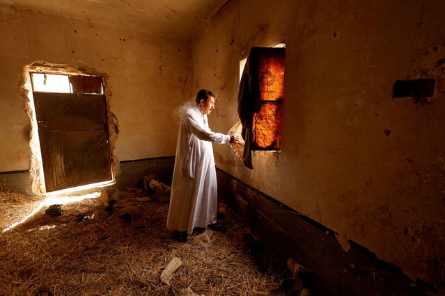 A man inspects his abandoned house, deserted due to a worsening water crisis, on the outskirts of Najaf, Iraq, on June 25, 2025. As Iraq bans summer farming and rice cultivation due to a deepening water crisis, farmers in Najaf are abandoning their lands and livelihoods. (Photo by Alaa Al-Marjani/Reuters)