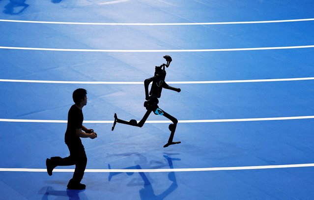 A Unitree Robotics humanoid robot takes part in a 400m race at the inaugural World Humanoid Robot Games, at the National Speed Skating Oval in Beijing, China on August 15, 2025. (Photo by Tingshu Wang/Reuters)