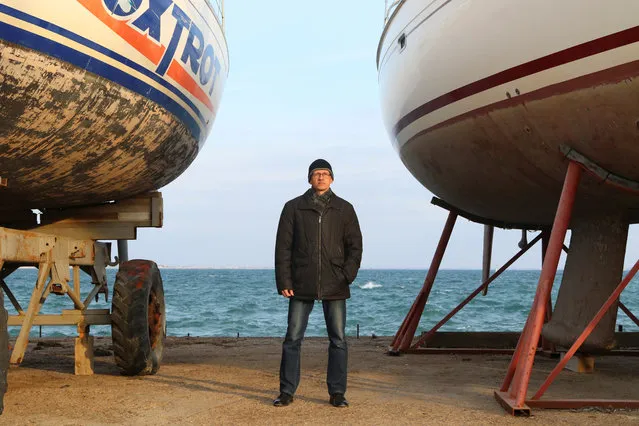 Andrei Lukinykh, 46, engineer and supporter of presidential candidate Vladimir Putin, poses for a picture in Yevpatoriya, Crimea, February 20, 2018. “I am going to vote, because I want stability. As the saying goes, you don't change your horses when crossing a river (at a turning point, during a difficult time)”, said Lukinykh. “Unlike the others, my candidate can provide the stability that's needed”. (Photo by Pavel Rebrov/Reuters)