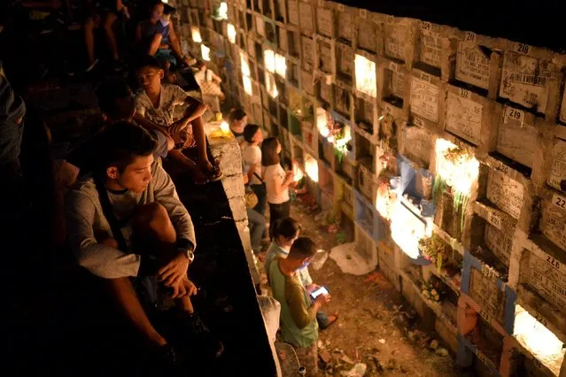 Filipinos visit the graves of their deceased loved ones, buried in "apartment style" tombs, inside a public cemetery in Marikina city, east of Manila November 1, 2015. (Photo by Ezra Acayan/Reuters)