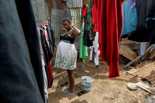 Secondary school student Jackline Bosibori, 17, who is pregnant, stands outside her home in Lindi village within the Kibera slums in Nairobi, Kenya, October 2, 2020. (Photo by Monicah Mwangi/Reuters)