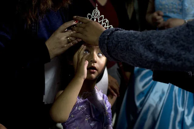 Mariela Flores, who is visually impaired, is crowned one of two Miss “Jacha Uru”, translated from the Aymaran language as Great Day, in La Paz, Bolivia, Friday, October 14, 2016. The families of people with disabilities, with the help of the city government, organized the pageant to promote the rights of children and adolescents with impairments that ranged from physical to sensory to developmental. About 50 contestants demonstrated their skills in singing or dancing, and wrapped up the competition sporting their finest evening wear. (Photo by Juan Karita/AP Photo)