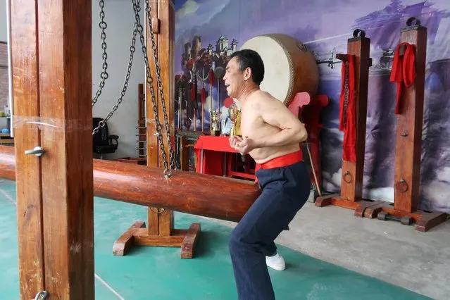 Wang Liutai demonstrates “Iron Crotch Kungfu” at his martial arts academy in Juntun village of Luoyang, Henan province, China on December 5, 2020. (Photo by Martin Pollard/Reuters)