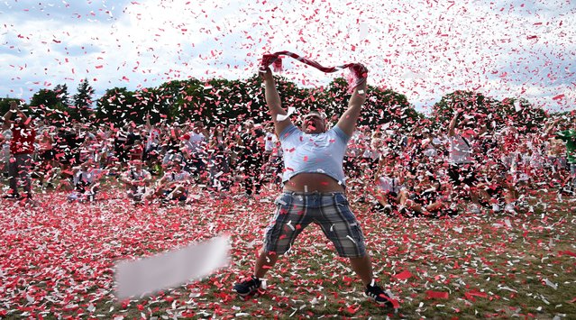 A Polish fan celebrates after the first goal for Poland at the public football viewing area in front of the National Stadium in Warsaw, Poland on June 16, 2024 during the UEFA Euro 2024 football match between Poland and Netherlands. (Photo by Sergei Gapon/AFP Photo)