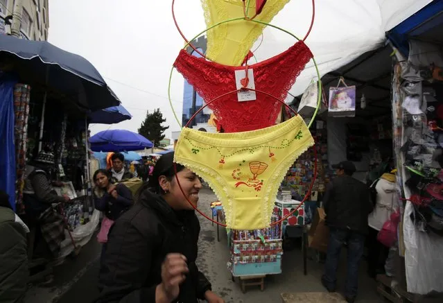 Underwear are hung for sale at a market in El Alto, on the outskirts of La Paz December 31, 2014. People buy red underwear for luck in love, and yellow underwear for good fortune, during end of year celebrations. (Photo by David Mercado/Reuters)