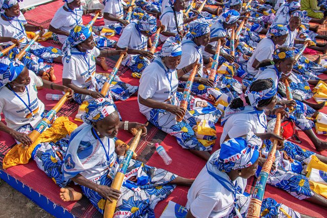 Women dressed in matching patterned outfits hold vuvuzelas printed with the image of President Paul Biya during a political rally at Lamido Yaya Dairou Stadium in Maroua, Cameroon, Tuesday, October 7, 2025. (Photo by Welba Yamo Pascal/AP Photo)