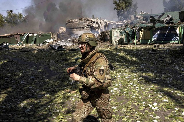 A Ukrainian soldier walks past the scene of a Russian strike minutes earlier near Pokrovsk in the Donetsk region of Ukraine on Sunday, August 17, 2025. (Photo by Finbarr O'Reilly/The New York Times/Redux)