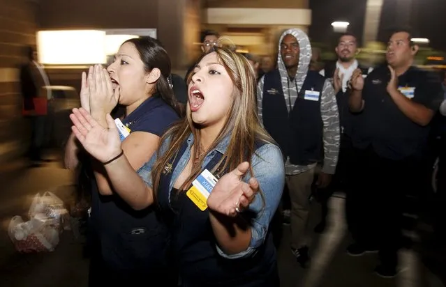 Current Walmart employees yell out that they love their jobs to former employees, who want a $15 per hour minimum wage and their jobs back, during a protest march at the store leading up to Black Friday in Pico Rivera, California November 19, 2015. (Photo by Alex Gallardo/Reuters)