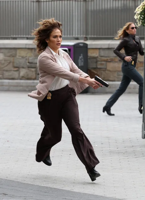 Jennifer Lopez shoots an intense action scene with gun at the ready on the set of her hit TV show “Shades of Blue” with costar Ray Liotta filming in Manhattan's Union Square Park. New York, NY on Tuesday, October 25, 2016. (Photo by LGjr-RG/PacificCoastNews)